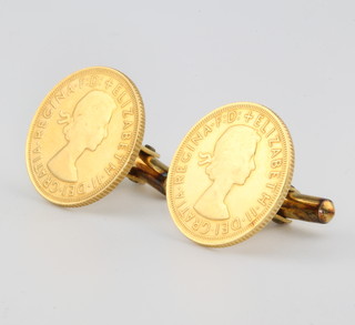 A pair of sovereign cufflinks 1958 and 1966 with 14ct yellow gold mounts 