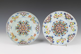 A near pair of 18th Century Lambeth Delft polychrome plates decorated with a central floral roundel enclosed by flowers 9" 