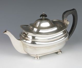A silver teapot with beaded rim, ball feet and ebonised mounts Birmingham 1929, gross weight 710 grams 