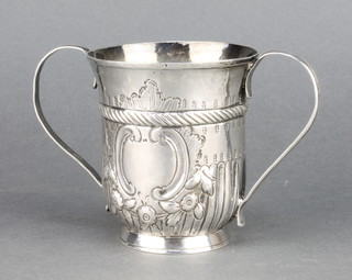 An Antique silver 2 handled cup with repousse decoration and vacant cartouche 176 grams