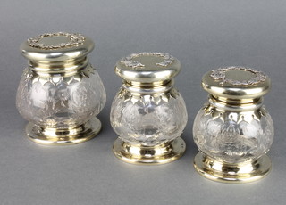 A set of 3 Victorian silver gilt mounted jars with floral decoration, the spherical bodies with flowers and scrolls 4" 