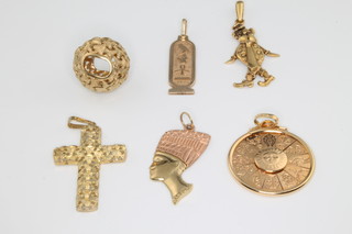 A 9ct yellow gold cross pendant and minor pendants, 18 grams
