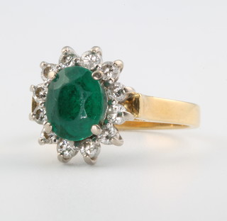 An 18ct yellow gold emerald and diamond ring size G