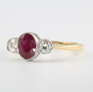 An 18ct yellow gold ruby and diamond ring, the oval stone approx. 0.7ct, the 2 brilliant cut diamonds approx 0.4ct, size O