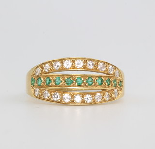An 18ct yellow gold emerald and diamond set dress ring size P 1/2