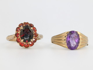 A 9ct yellow gold amethyst set ring size N 1/2 and a do. garnet set cluster ring size M