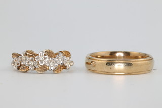 A 9ct yellow gold single stone diamond set wedding band size S, 4.9 grams and a 9ct paste set ring size N 1/2