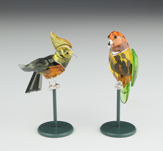 A Swarovski Crystal coloured figure of a parrot on perch 3 1/2" together with a ditto parakeet 3 1/2" both with silver mounts