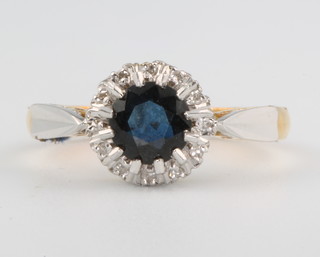 An 18ct yellow gold sapphire and diamond cluster ring size M 