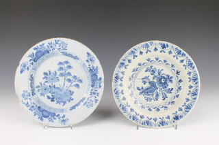 An 18th Century English Delft blue and white plate decorated with flowers enclosed in a floral border 9", a do. dish decorated with stylised flowers 9" 