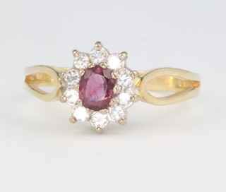 An 18ct yellow gold ruby and diamond cluster ring size P