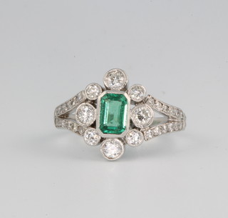 An 18ct white gold emerald and diamond ring size N