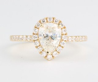 An 18ct yellow gold pear shaped diamond ring, the centre stone approx. 1.04ct surrounded by brilliant cut diamonds, size M, together with an EDR diamond report, colour H, clarity VS2