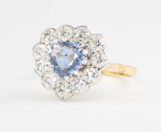 An 18ct white gold heart shaped sapphire and diamond cluster ring, the sapphire approx 0.90ct surrounded by 10 brilliant cut diamonds approx. 1.12ct size N 