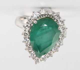 An 18ct white gold pear cut emerald and diamond ring, the centre stone approx. 5.82ct surrounded by brilliant cut diamonds approx 1.23ct 