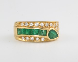 An 18ct yellow gold emerald and diamond dress ring, size M