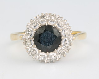 An 18ct yellow gold sapphire and diamond cluster ring, size M 1/2