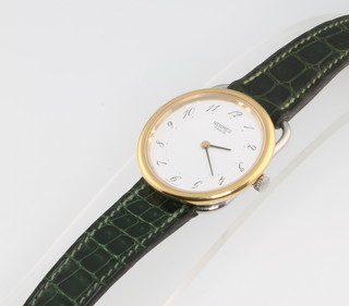 A gentleman's Hermes gilt and steel wrist watch on a ditto leather strap