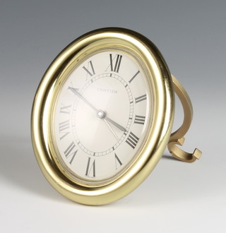 A Cartier timepiece contained in a gilt case with easel stand and cabuchon set buttons 3 1/2" 