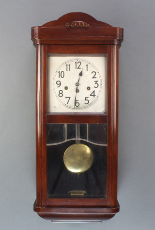 An Art Deco 8 day chiming wall clock with silvered dial and Arabic numerals contained in a mahogany case 