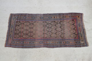 A red and blue ground Caucasian runner, the rectangular central medallion with overall geometric design within multi-row border, in wear,  94" x 47" 