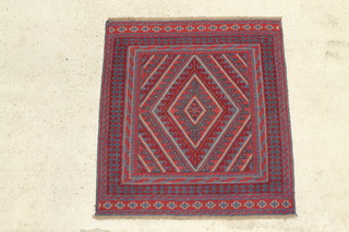 A red and blue ground Tribal Gazak rug with diamond shaped medallion to the centre within a multi row border 50" x 45" 