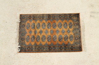 A rust ground Bokhara rug with 18 octagons to the centre 47" x 31" 