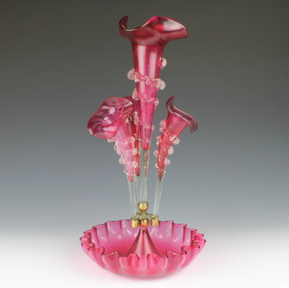A Victorian cranberry glass epergne with large centre tapered vase and 3 small ditto with a wavy line base 18" 