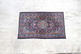 A Persian blue and floral ground Kirman rug with central medallion 59" x 35 1/2" 