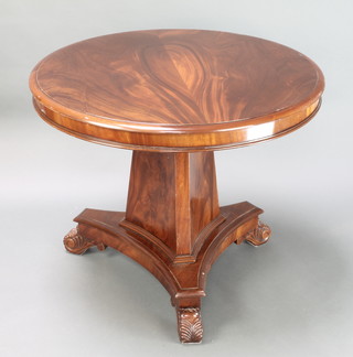 A Regency style circular mahogany breakfast table raised on chamfered column and triform base with scroll feet 29"h x 35"diam. 