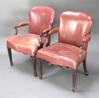 A pair of Georgian style mahogany library chairs, the seats of serpentine outline upholstered in red leather, raised on turned and fluted supports 