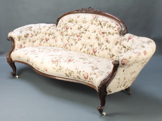 A Victorian carved walnut show frame sofa with arch raised back, the base  of serpentine outline, upholstered in floral button backed material, raised on cabriole supports 36"h x 78"w x 28"d 
