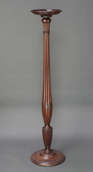 An Edwardian turned and reeded mahogany torchere raised on a circular base 56"h x 11" diam. 