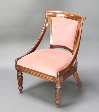 A Victorian mahogany Continental bar back nursing chair, the seat and back upholstered in pink Dralon raised on turned and reeded supports 