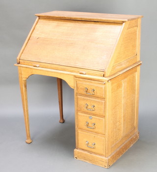 An Arts & Crafts light oak roll top desk, the wedge shaped top with fitted pigeon holes and drawer, the base fitted a brushing slide above 4 long drawers with brass swan neck drop handles 40 1/2"h x 36"w x 24"d 