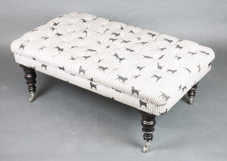 A rectangular Victorian style footstool/window seat with dog print buttoned upholstered raised on turned supports with silvered caps and casters 18"h x 46"w x 26"d 