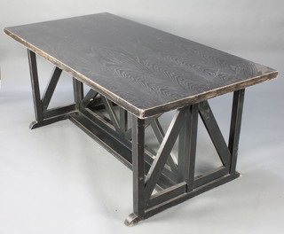 An Art Nouveau style ebonised dining table raised on angled supports 29 1/2"h x 71"l x 35 1/2"w