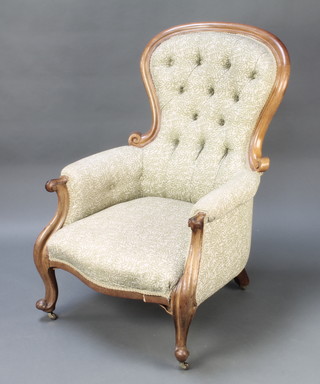 A Victorian mahogany show frame armchair upholstered in green coloured material, raised on cabriole supports (leg requires some attention) 