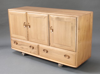 An Ercol Windsor light elm sideboard fitted triple cupboards above 2 long drawers 30"h x 51"w x 17"d