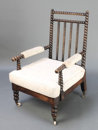 A Victorian open arm chair with bobbin turned decoration 