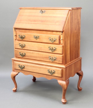 A hardwood bureau, the fall front revealing a well fitted interior above 4 long drawers raised on cabriole supports 39"h x 25"w x 18"d 