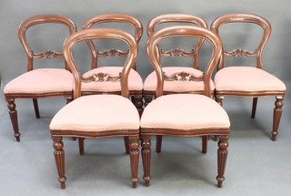 A set of 6 Victorian style mahogany balloon back dining chairs with shaped mid rails and over stuffed seats 