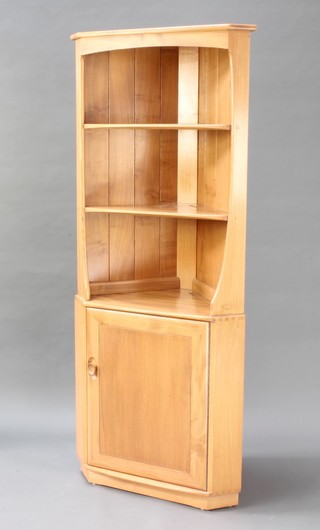 An Ercol Windsor light elm double corner cabinet the upper section with moulded cornice fitted 3 recesses, the base enclosed by a panelled door 71"h x 30"w x 17"d 
