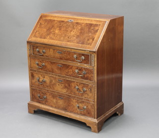 A Queen Anne style inlaid figured walnut bureau, the fall front above 4 long drawers, raised on bracket feet 36"h x 29"w x 18"d 