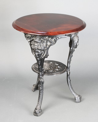 A cast iron pub table with mahogany top raised on cherub mask cabriole supports 27"h x 23 1/2" (f)