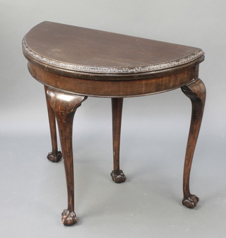 A Georgian style demi-lune card table raised on cabriole ball and claw supports 29"h x 31"w x 16"d 