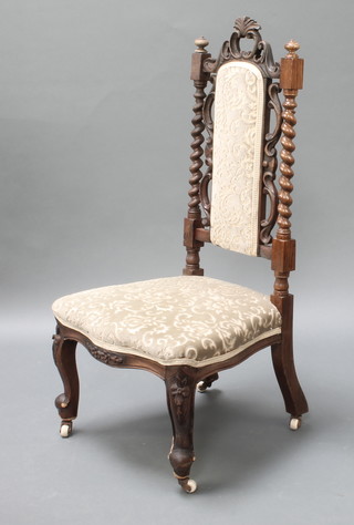 A Victorian oak nursing chair with spiral turned columns the seat and back upholstered in Dralon 