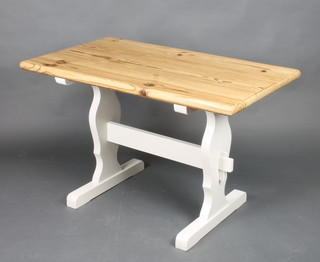A pine refectory dining table, raised on a white painted base with H framed stretcher 29"h x 47"l x 26 1/2"w