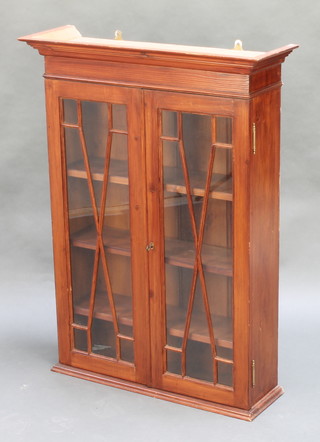 A mahogany bookcase enclosed by glazed panelled doors with shelved interior and moulded cornice 37 1/2"h x 27 1/2"w x 9"d 