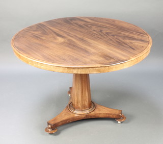 A circular Victorian mahogany breakfast table raised on a chamfered column with triform base 27"h x 41" diam. 
